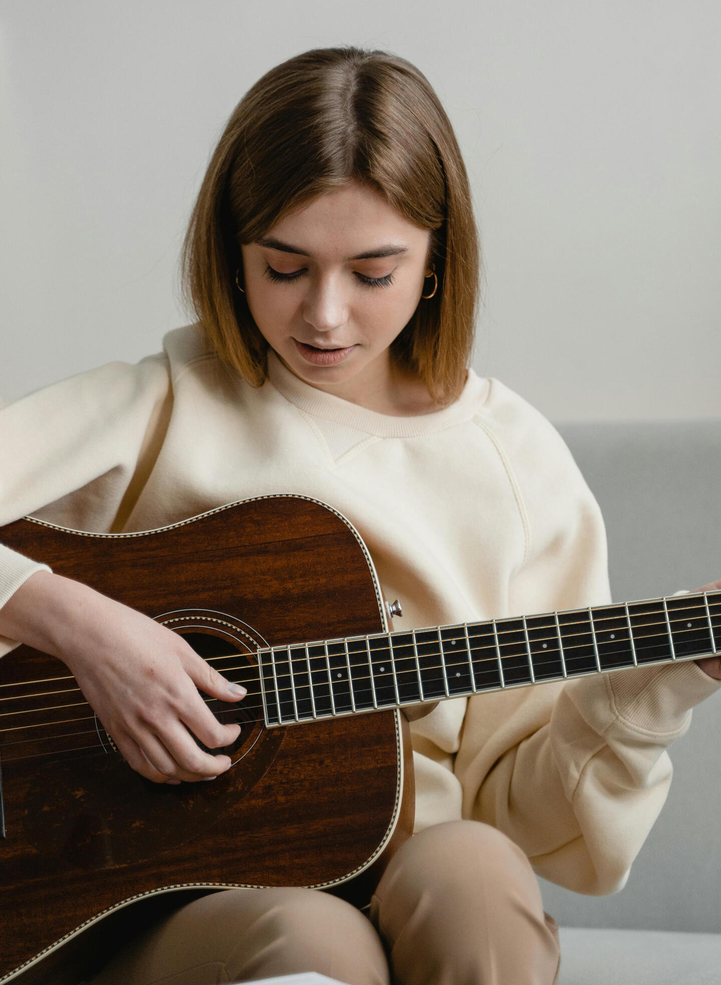An image of a student practicing guitar. Applying music theory concepts to the instrument. An image of a student practicing guitar. Applying music theory concepts to the instrument.